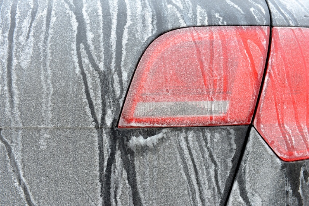 Rear of a car coated in road salt and grime during winter in Colorado – showing how car paint can fade or get damaged by harsh weather and road treatments.