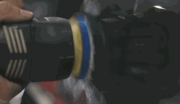 Polisher machine in action buffing a car's surface during the ceramic coating process, creating a smooth and reflective finish.