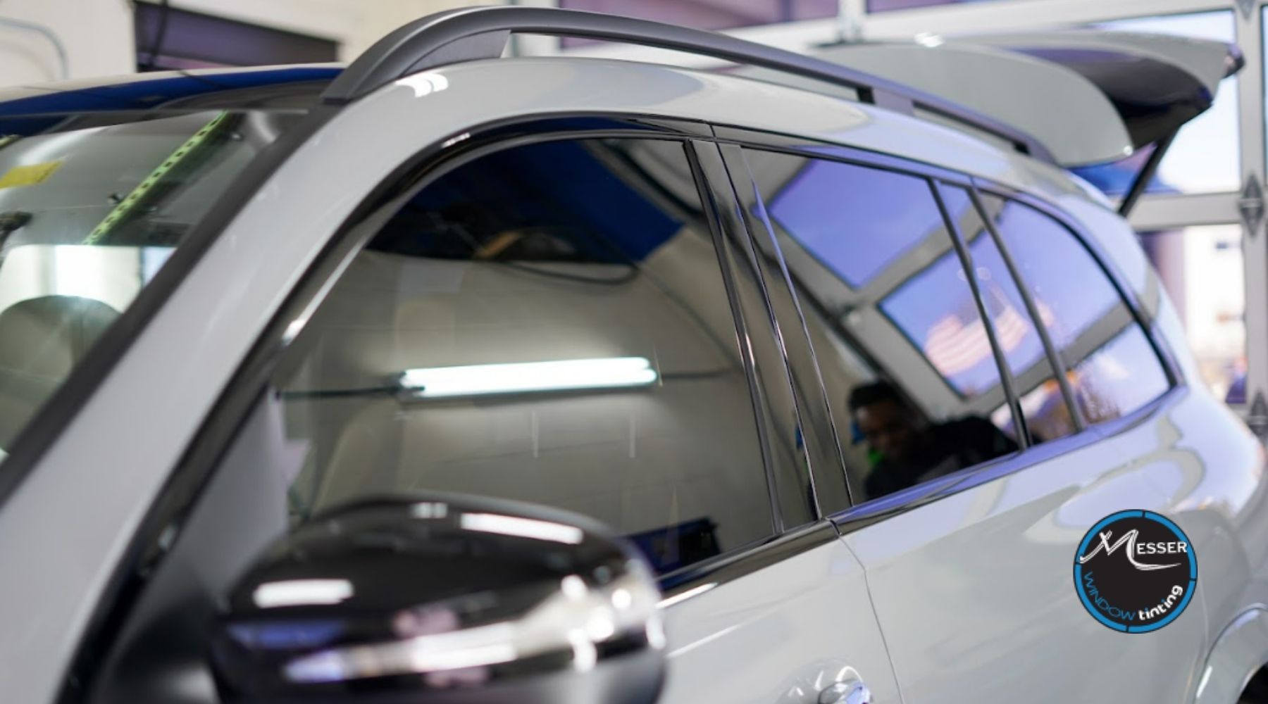 White SUV with professionally installed window tint inside Messer Window Tinting shop in Parker, CO.
